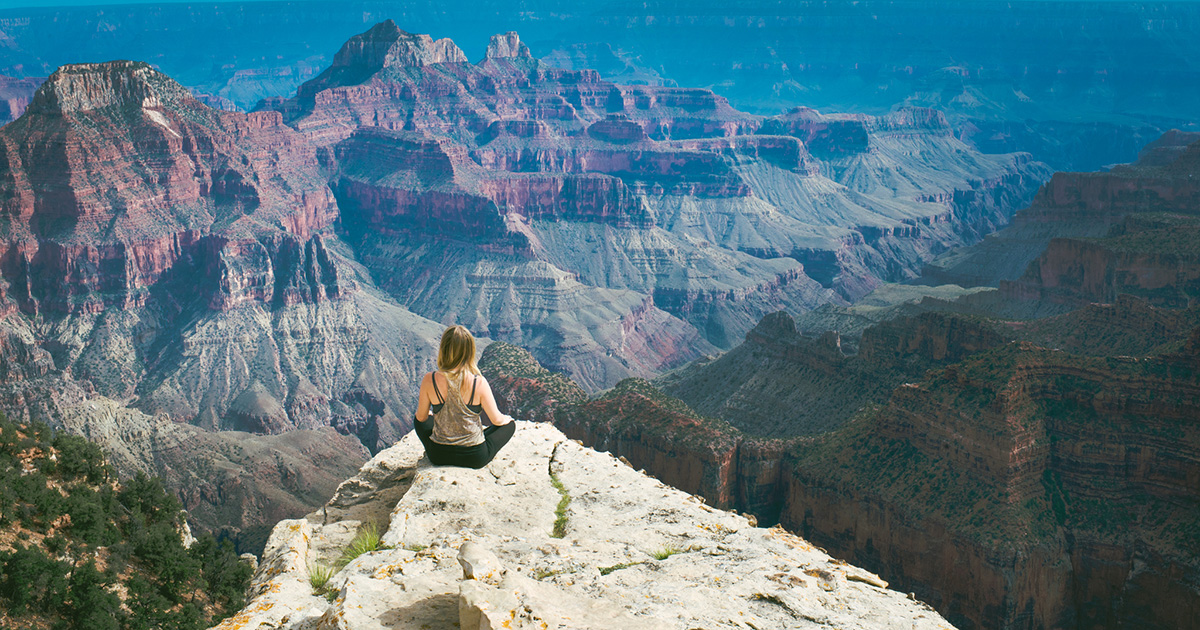 woman sitting on beautiful overlook